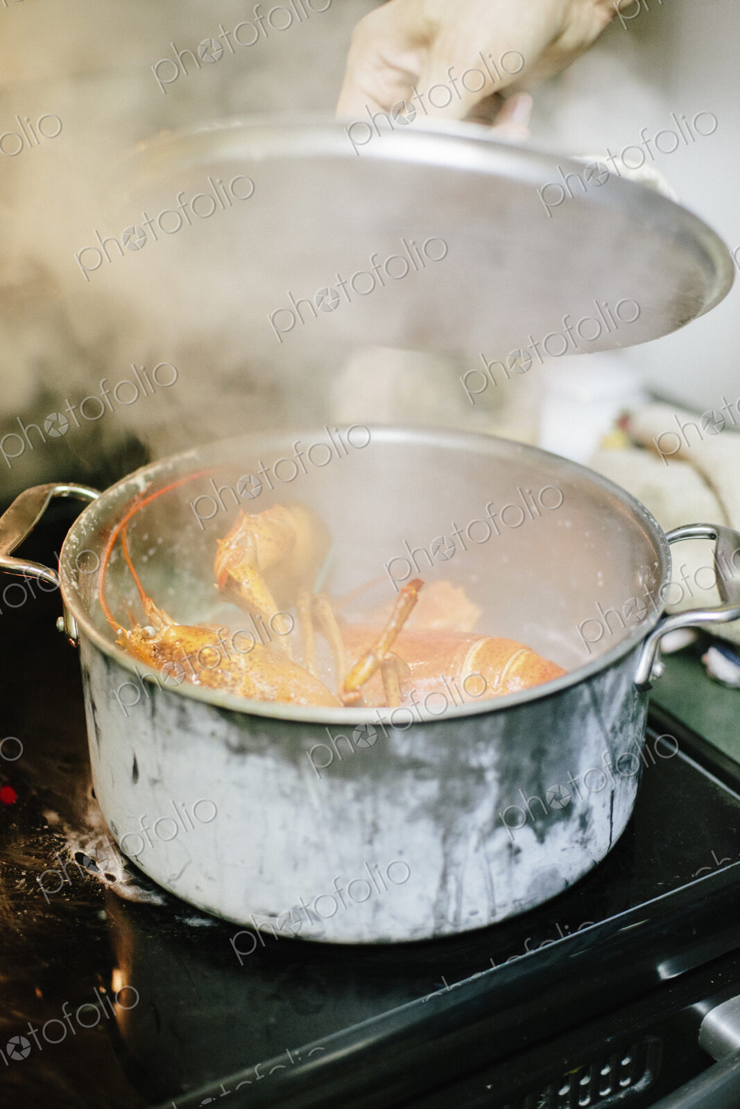A lobster cooking in a pot.