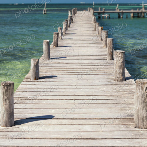 A long wooden jetty or pier,stretching out over the water A long wooden jetty or pier,stretching out over the water