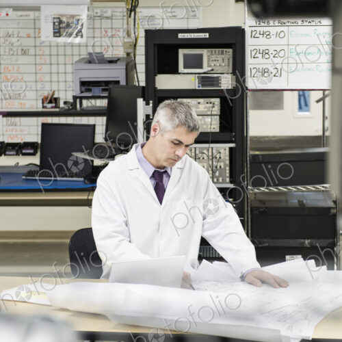 A male caucasian technician working over a problem r in a technical research and… A male caucasian technician working over a problem r in a technical research and…