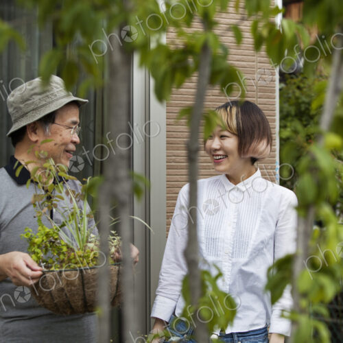 A man and a woman standing in their garden.