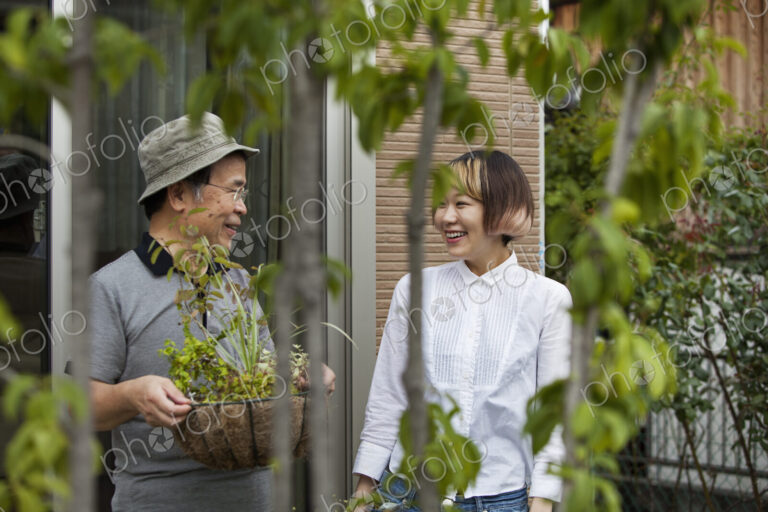 A man and a woman standing in their garden.