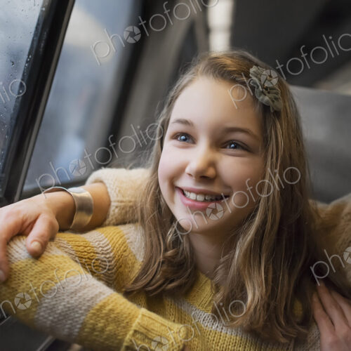 A man and a young girl sitting beside the window in a train carriage looking out at… A man and a young girl sitting beside the window in a train carriage looking out at…