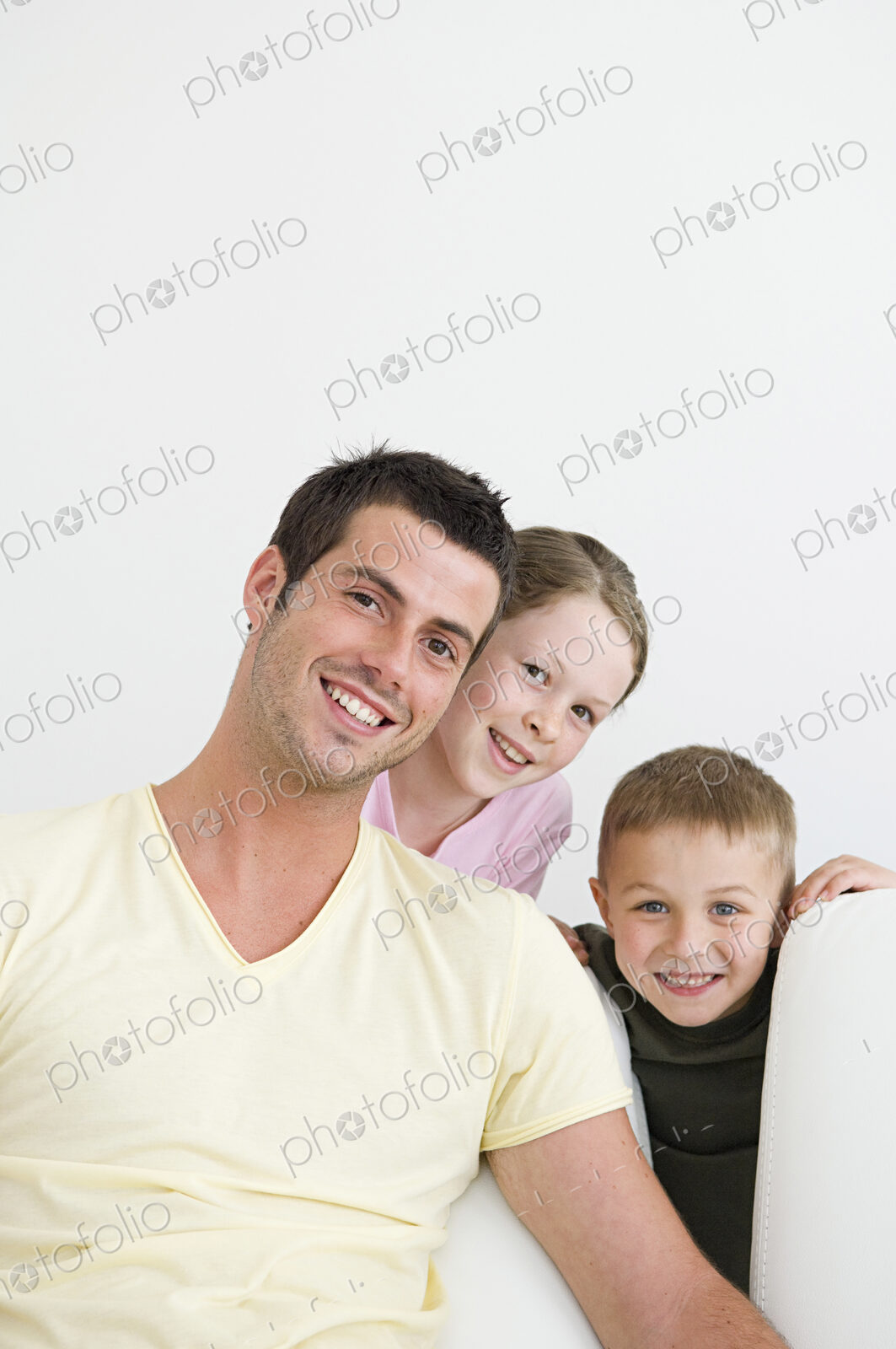 A man and two children at home, a boy and a girl.