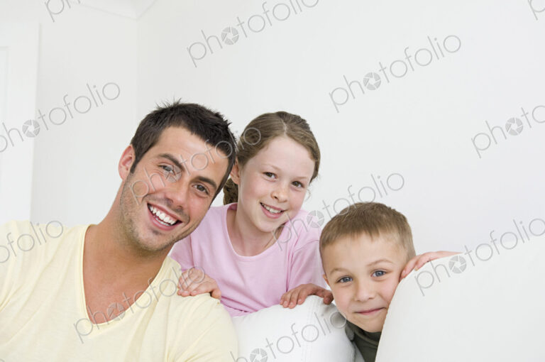 A man and two children at home, a boy and a girl.