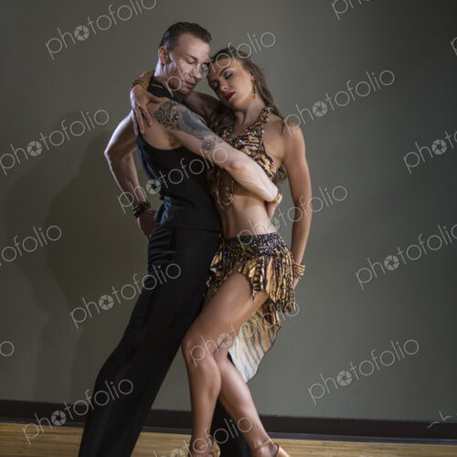 A man and woman dancing together in a dance studio.