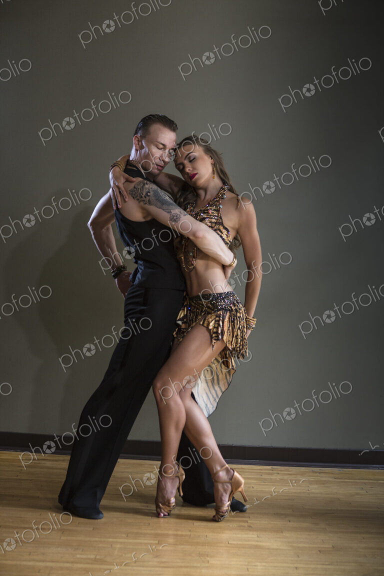 A man and woman dancing together in a dance studio.