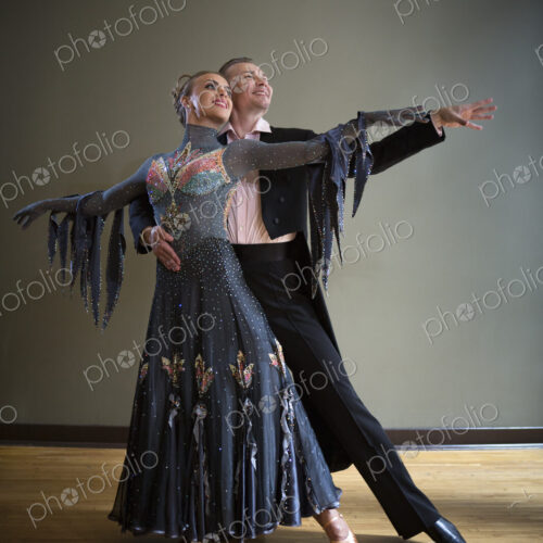 A man and woman dancing together in a dance studio. A man and woman dancing together in a dance studio.