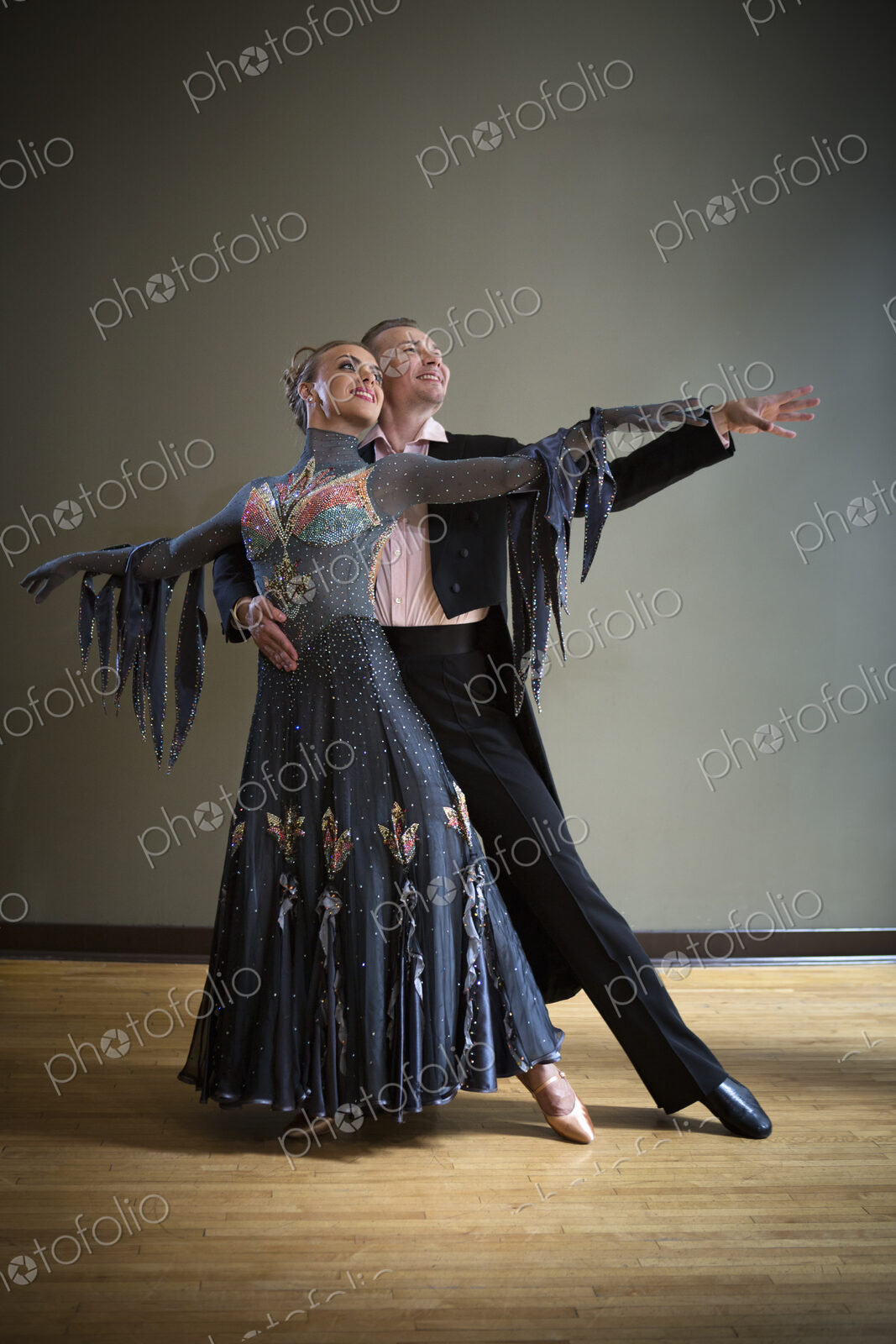 A man and woman dancing together in a dance studio.