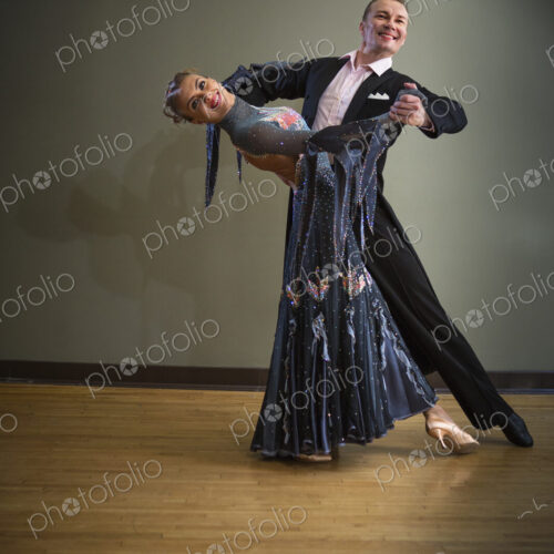 A man and woman dancing together in a dance studio.