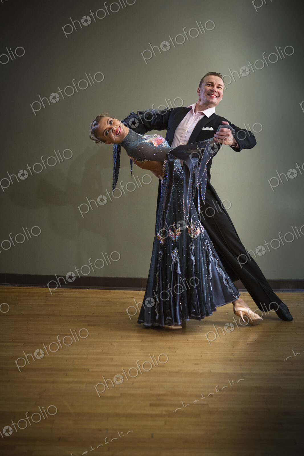 A man and woman dancing together in a dance studio.