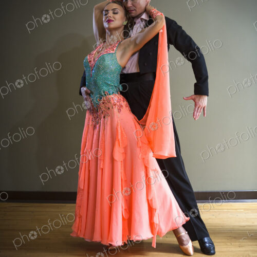A man and woman dancing together in a dance studio.