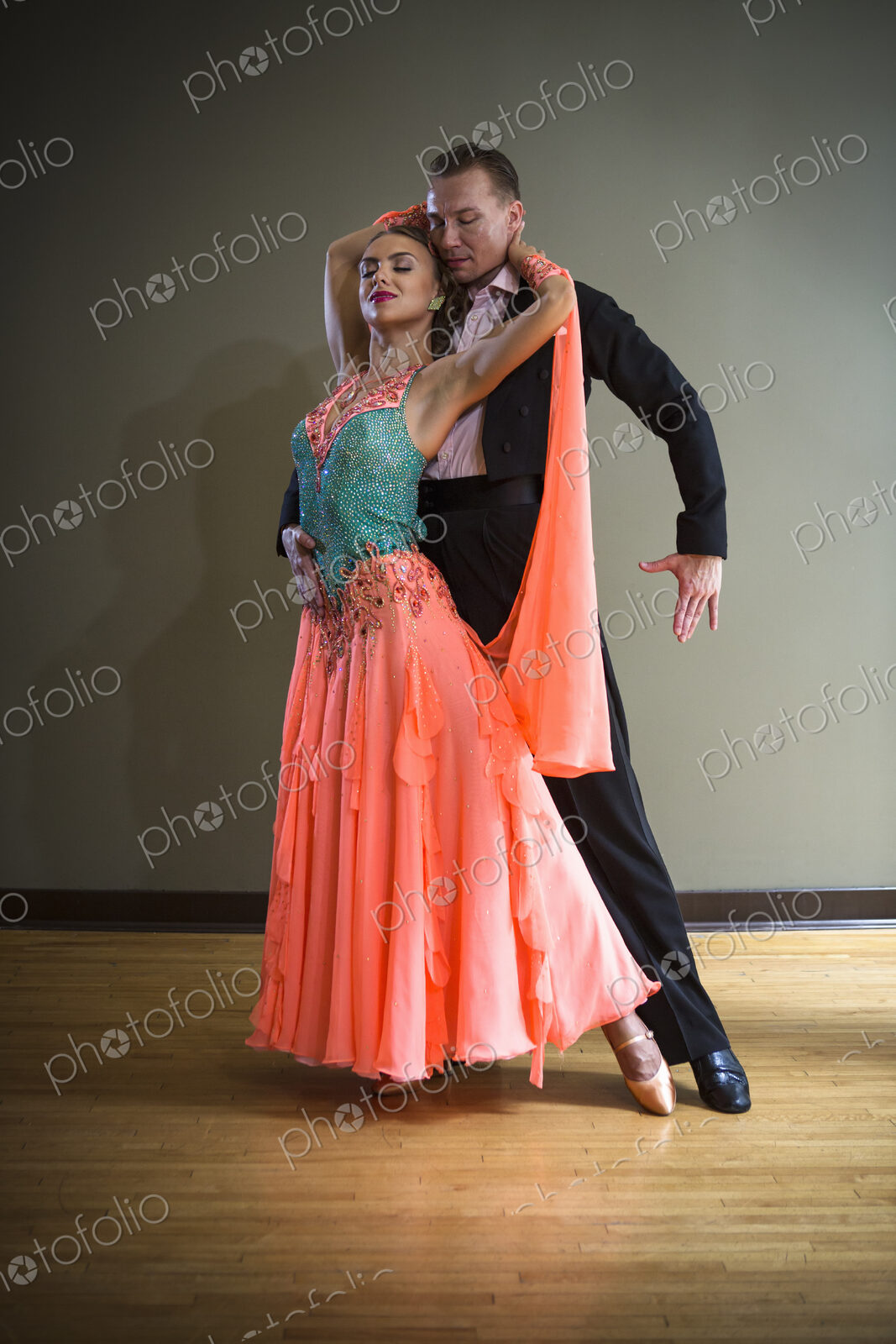 A man and woman dancing together in a dance studio.