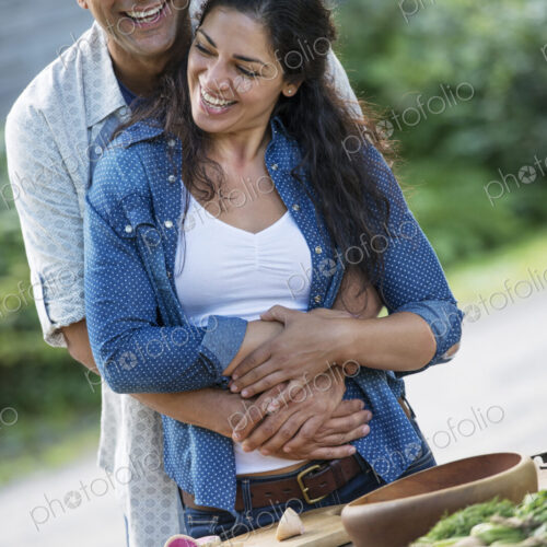 A man and woman together outdoors in summer.