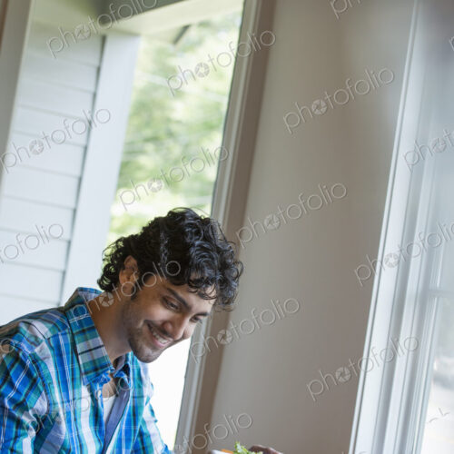 A man checking his phone at a cafe table.