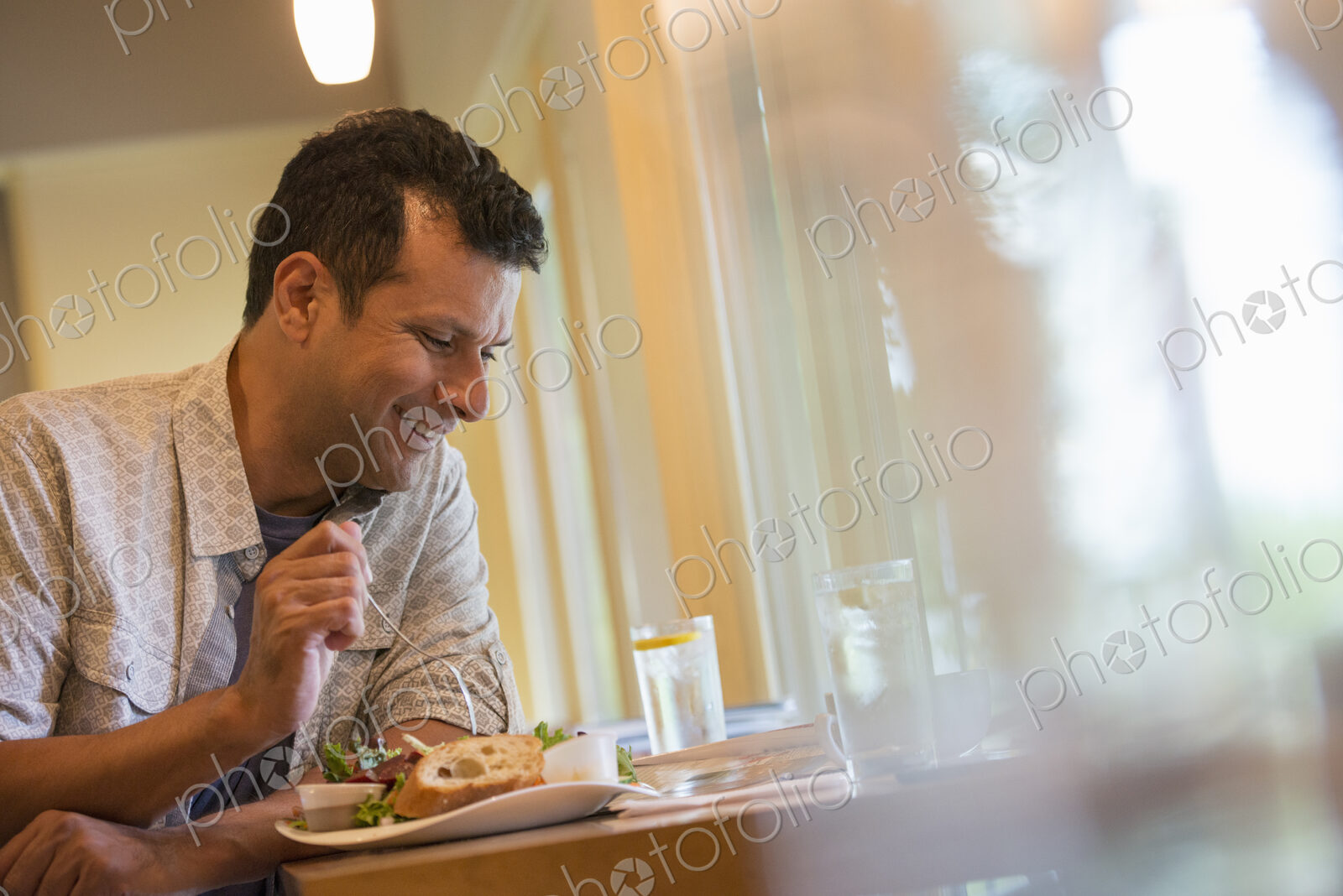 A man eating a snack in a cafe.