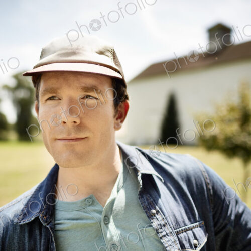 A man in a baseball cap on an organic farm in New York State. A man in a baseball cap on an organic farm in New York State.