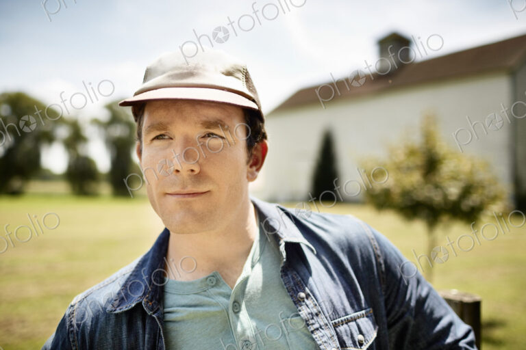 A man in a baseball cap on an organic farm in New York State.