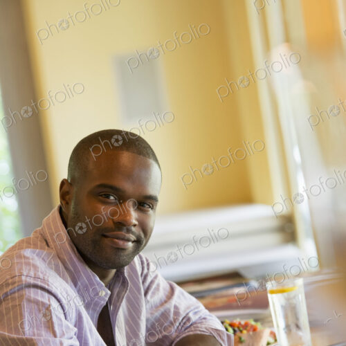 A man in a cafe, using a digital tablet.
