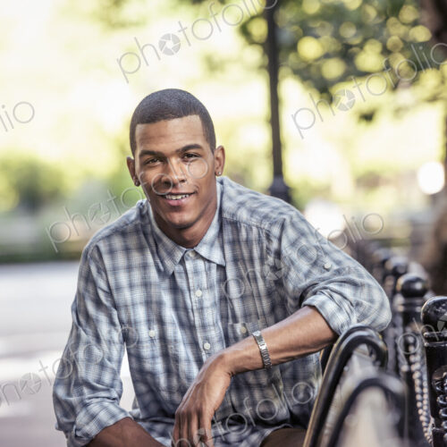 A man seated in a city park relaxing on a bench A man seated in a city park relaxing on a bench