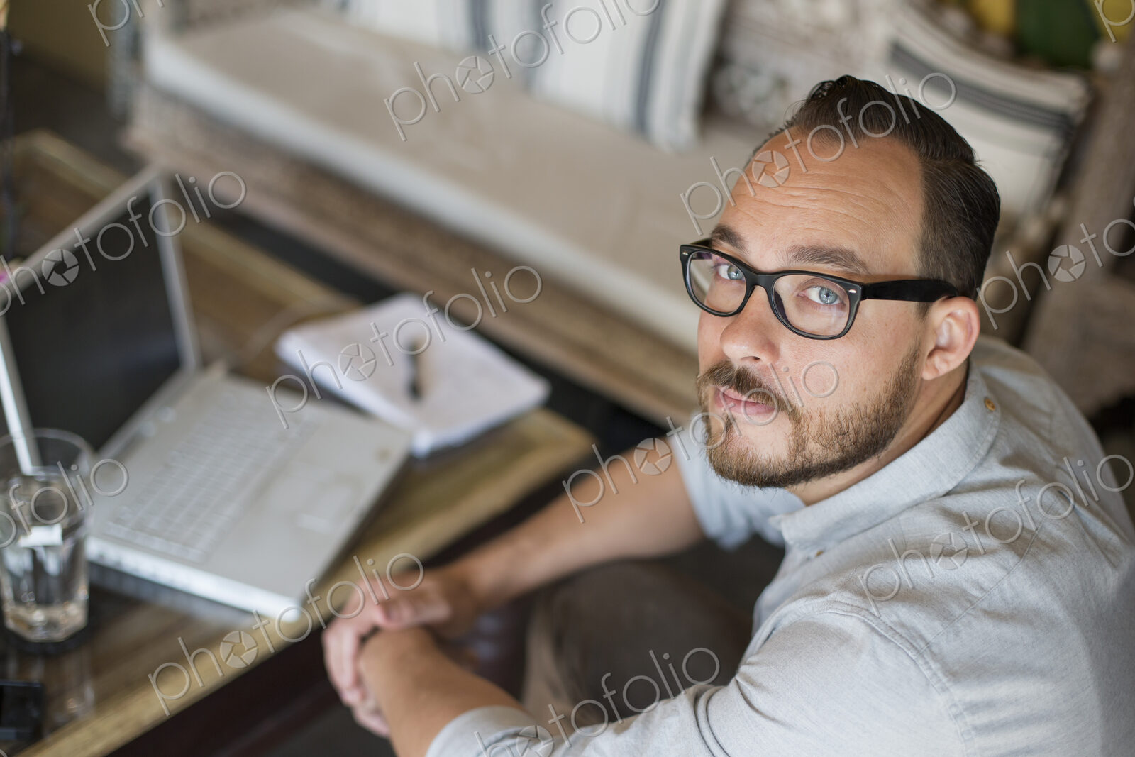 A man sitting at a desk using a laptop computer. Running a small business.