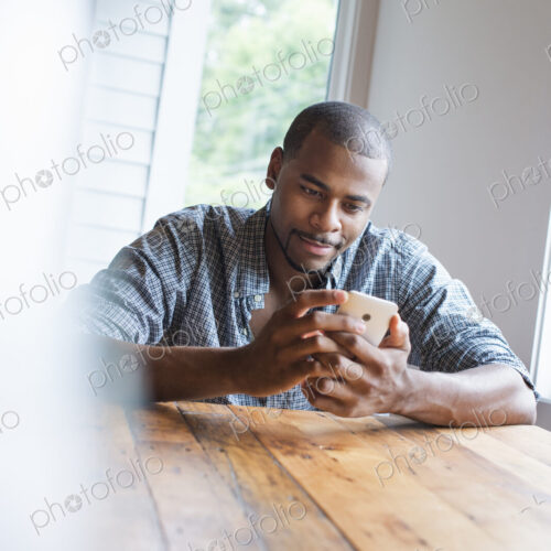 A man sitting in a cafe with a cup of coffee.