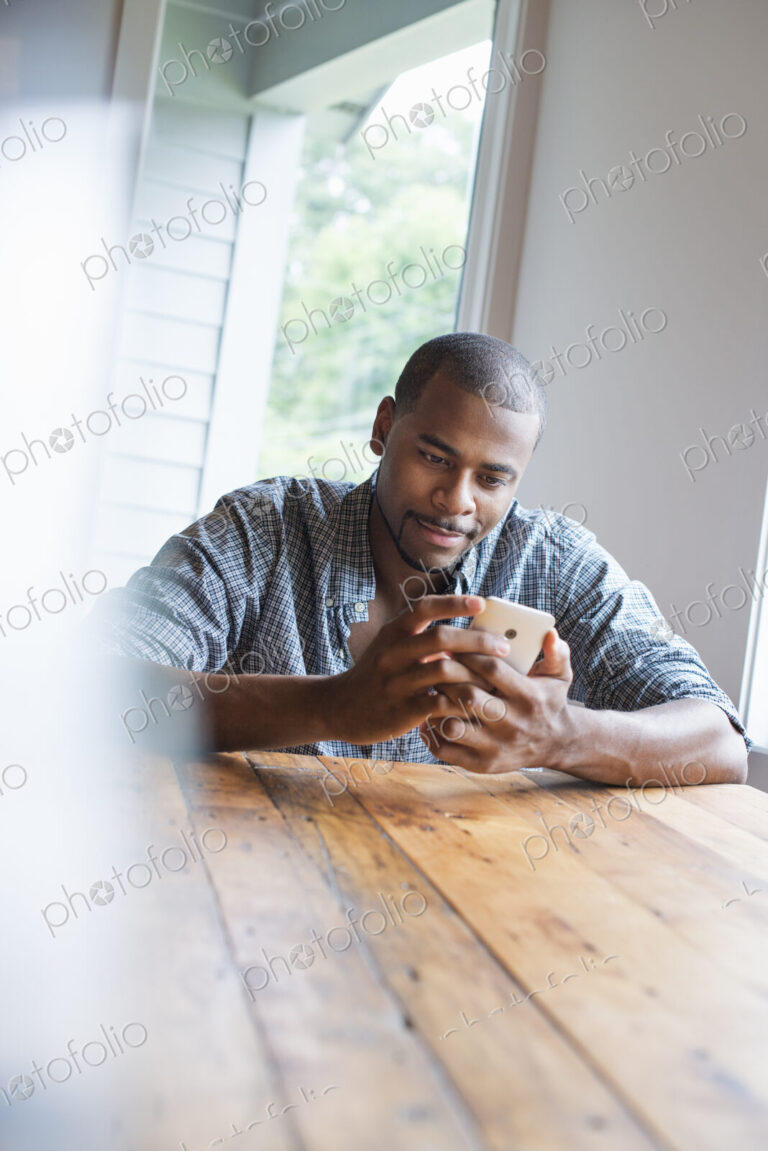 A man sitting in a cafe with a cup of coffee.