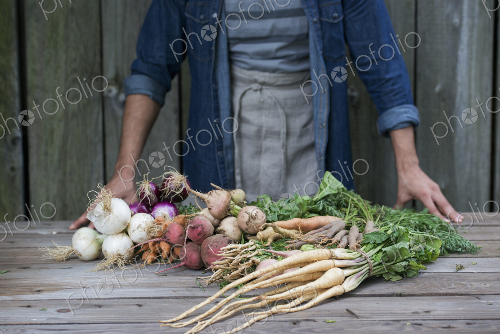 A man sorting freshly picked vegetables on a table.