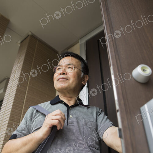 A man standing at his front door.