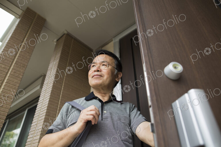 A man standing at his front door.