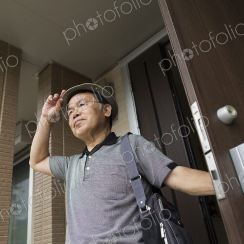 A man standing at his front door.