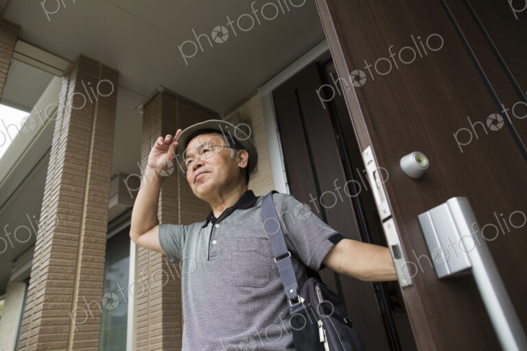 A man standing at his front door.