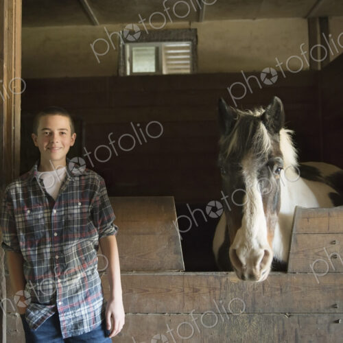 A man standing beside a horsebox in the stables at an animal sanctuary. A horse with… A man standing beside a horsebox in the stables at an animal sanctuary. A horse with…