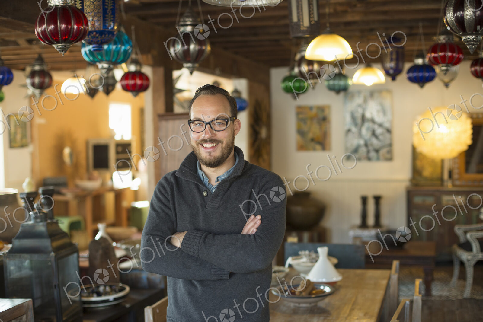 A man standing in a shop full of antique and decorative objects. Antique shop…