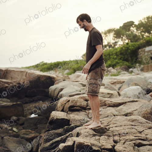 A man standing on the beach, overlooking the rockpools. A man standing on the beach, overlooking the rockpools.
