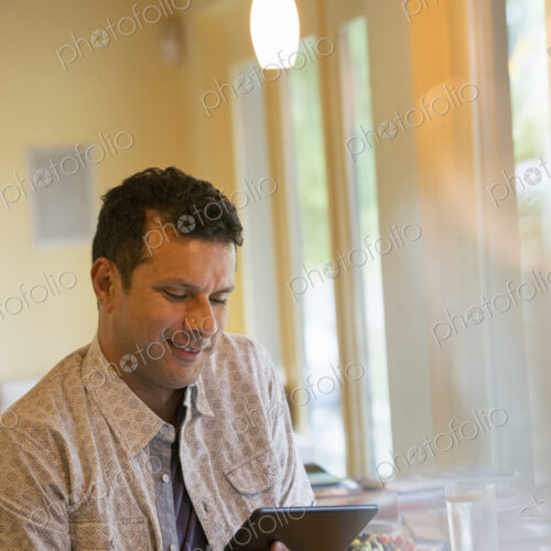 A man using a digital tablet. A man using a digital tablet.