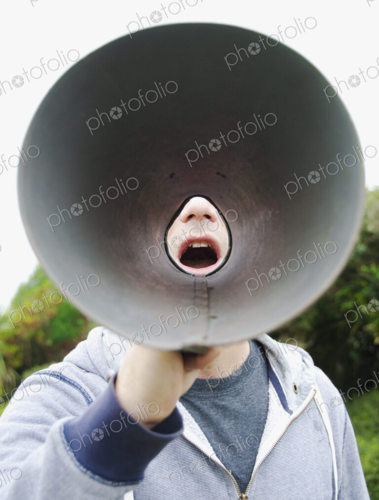 A man using a megaphone, view from the wide cone end.