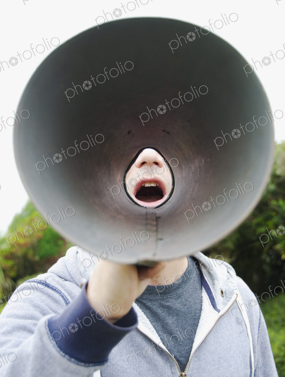 A man using a megaphone, view from the wide cone end.