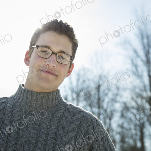 A man wearing a woollen jumper, looking at the camera. A cold winter day. A man wearing a woollen jumper, looking at the camera. A cold winter day.