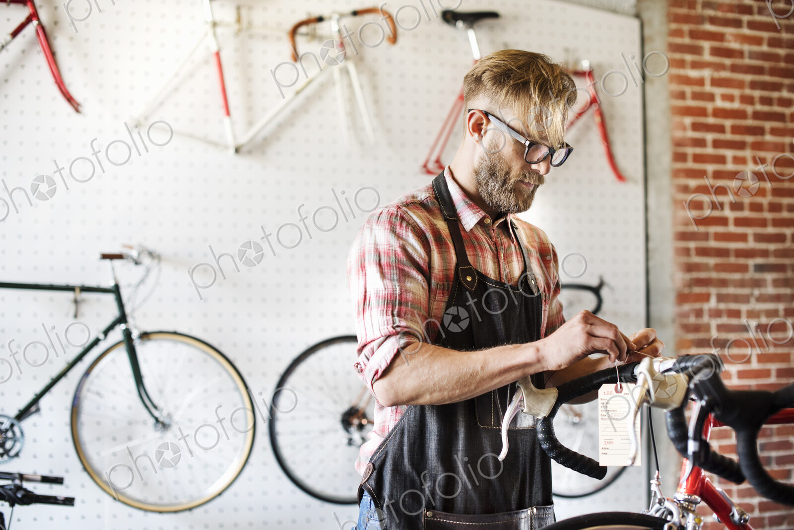 A man working in a bicycle repair shop.