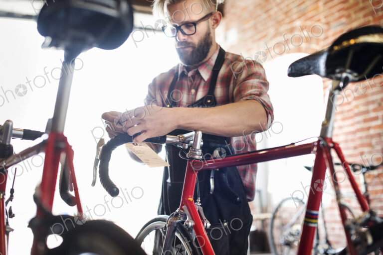 A man working in a bicycle repair shop.