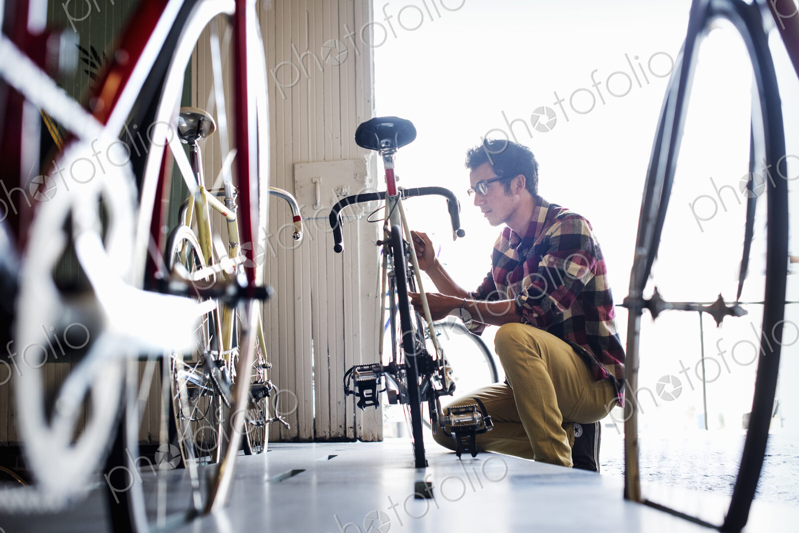 A man working in a bicycle repair shop.
