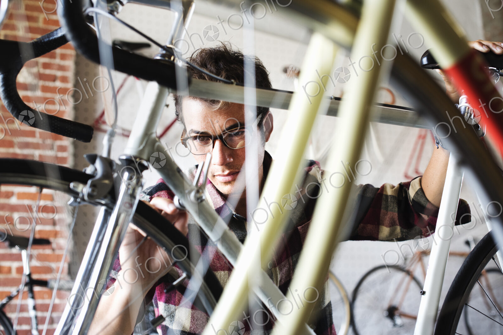 A man working in a bicycle repair shop.