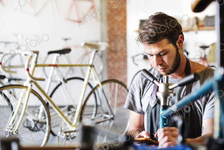 A man working in a bicycle repair shop.