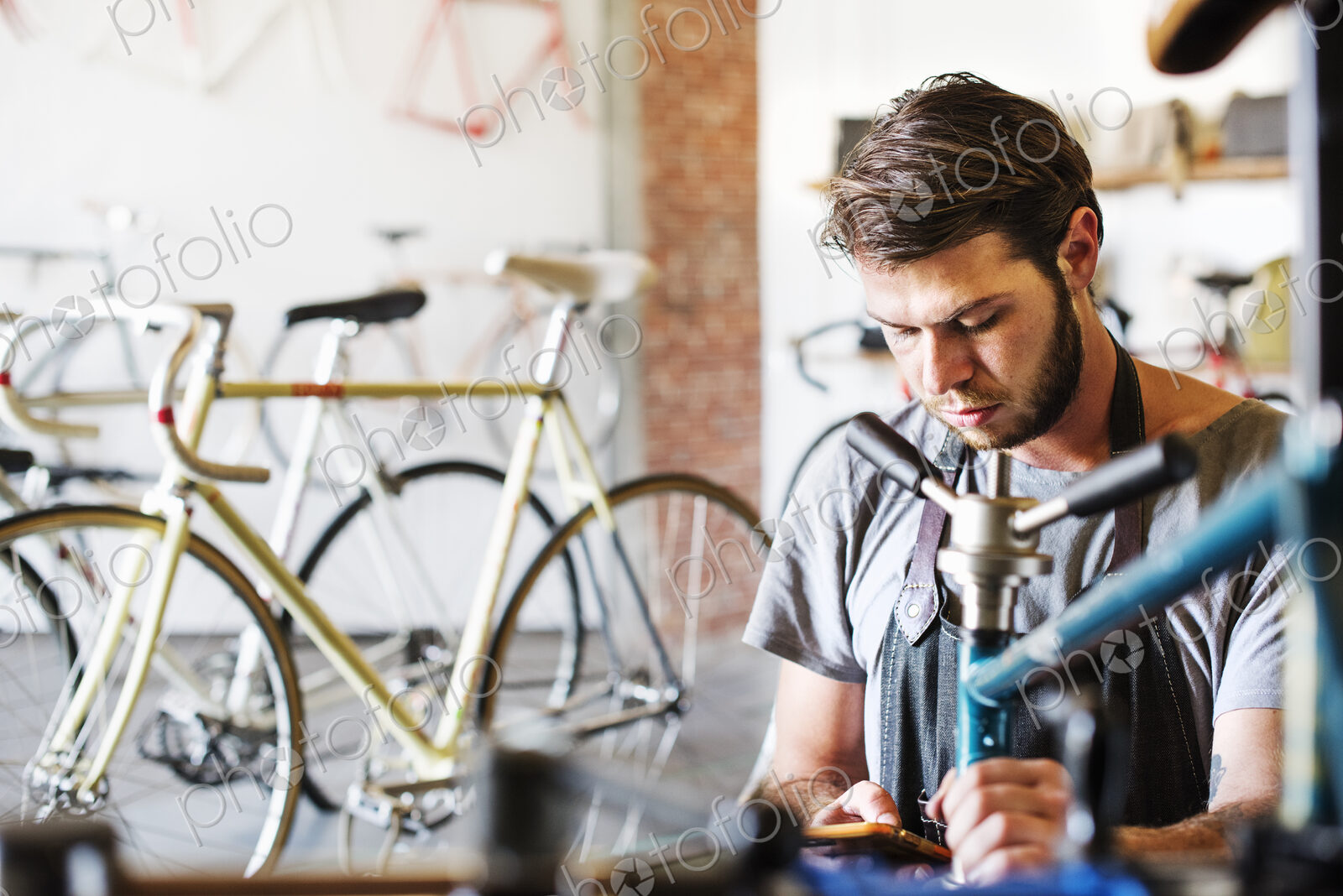 A man working in a bicycle repair shop.