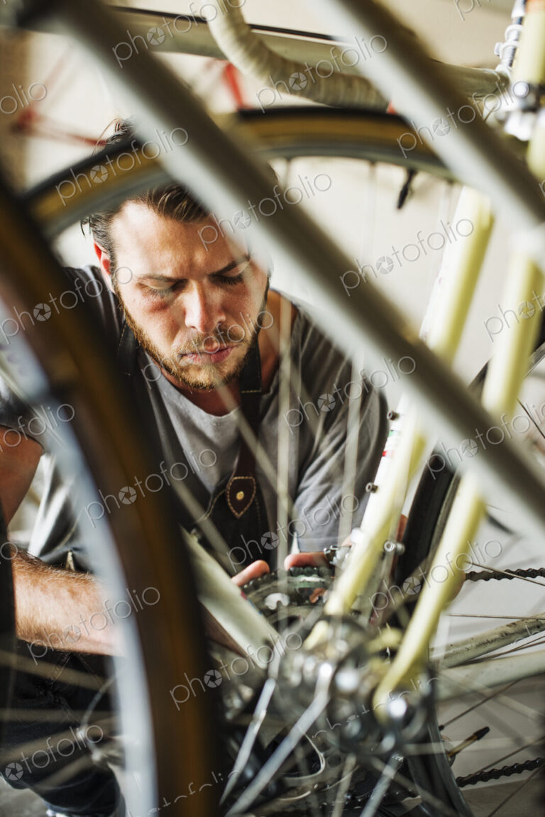 A man working in a bicycle repair shop.