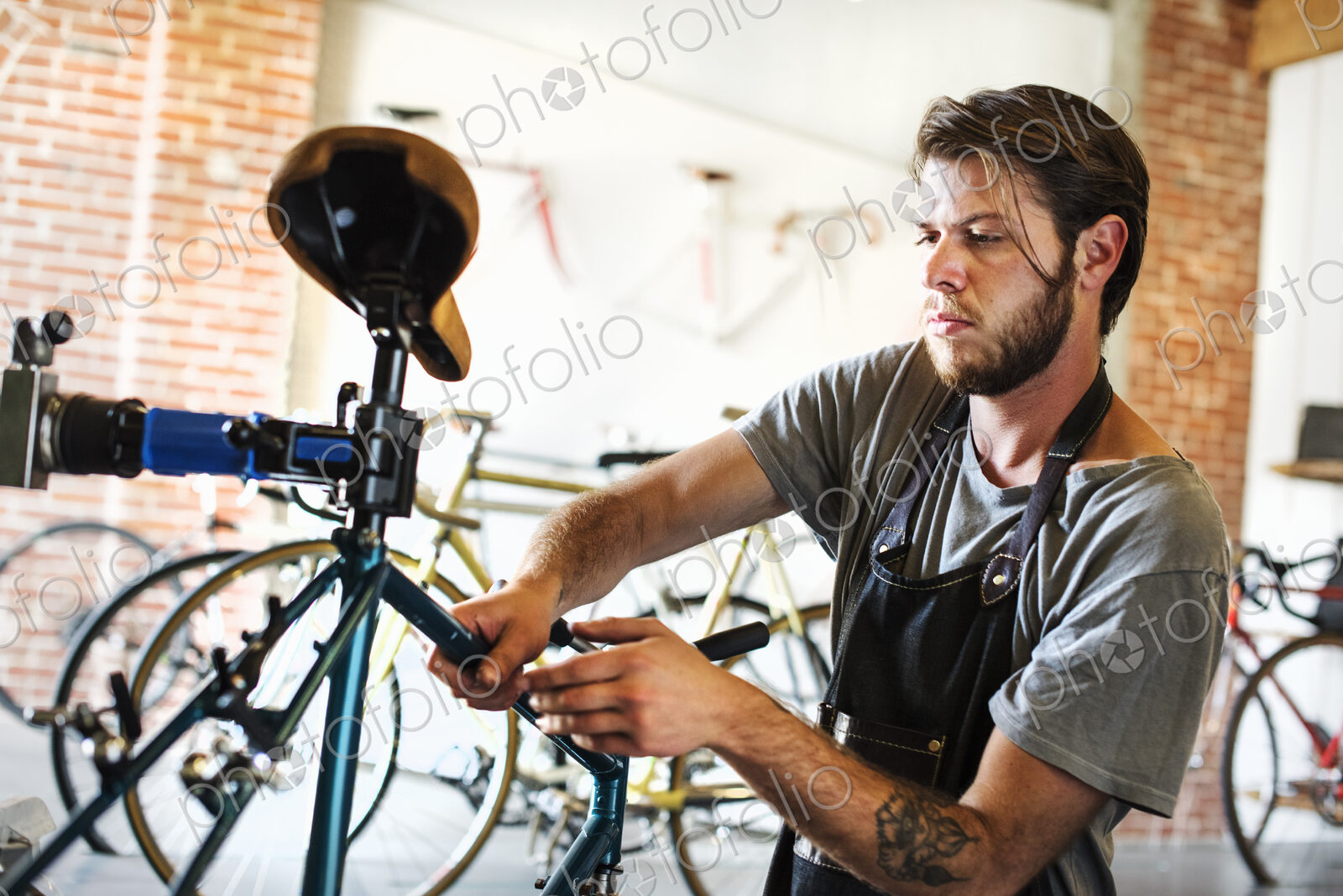 A man working in a bicycle repair shop, checking the frame of the bike.