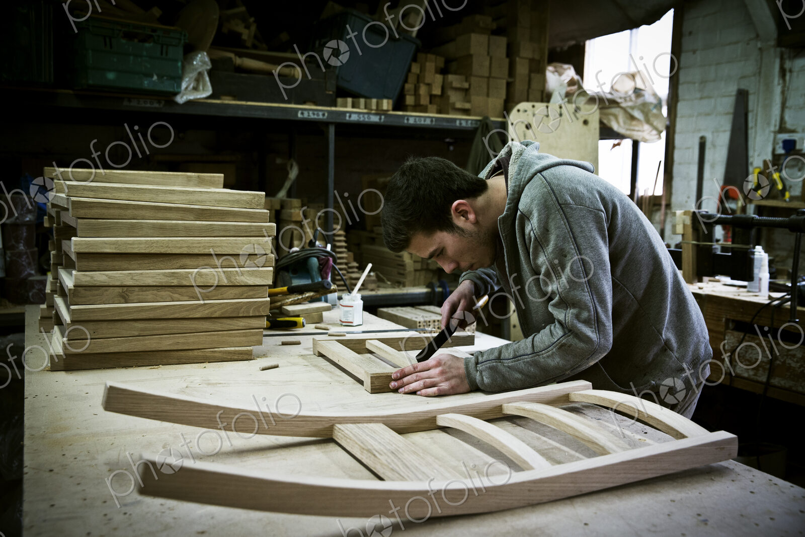A man working in a furniture maker’s workshop.