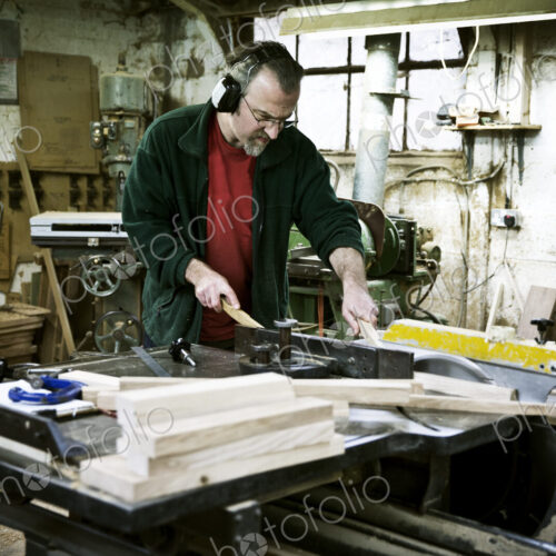 A man working in a furniture maker's workshop.