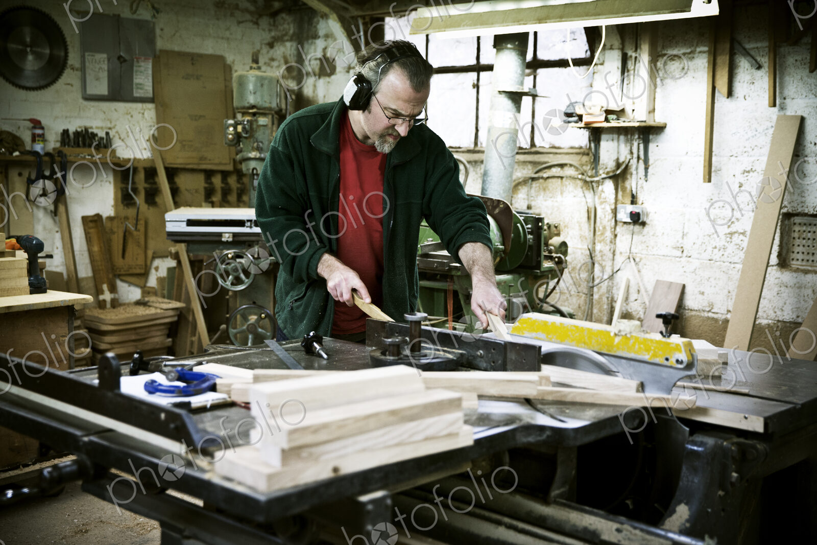 A man working in a furniture maker’s workshop.
