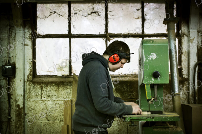 A man working in a furniture maker's workshop.